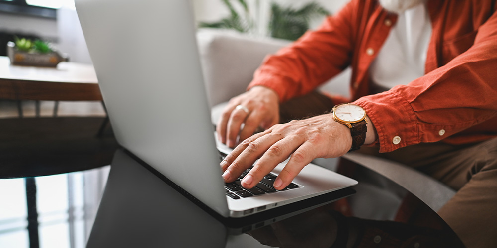 Man at laptop computer typing